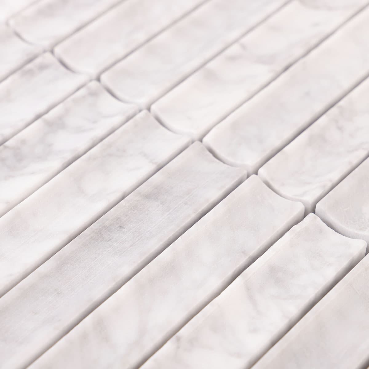 Close-up of concave fluted white marble mosaic tile