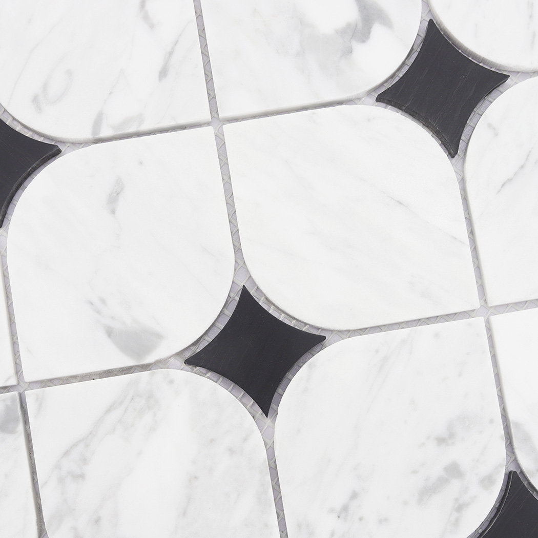 Detailed view of white marble mosaic tile pattern with black square accents