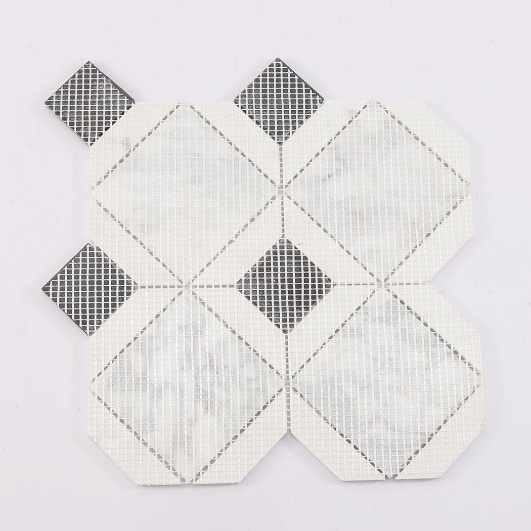 Back view of white marble mosaic tile showing mesh backing and black inserts