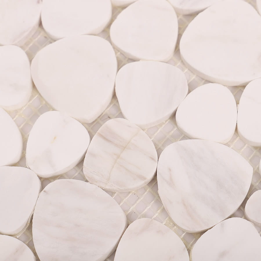 Close-up of white marble pebble mosaic tiles with natural texture