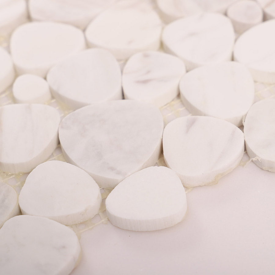 Side view of white marble pebble mosaic tiles showing thickness