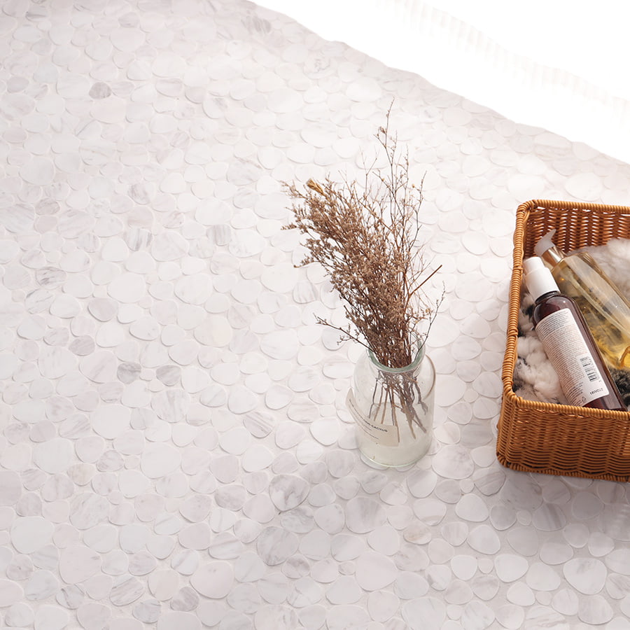 White marble pebble mosaic tile flooring with vase and basket