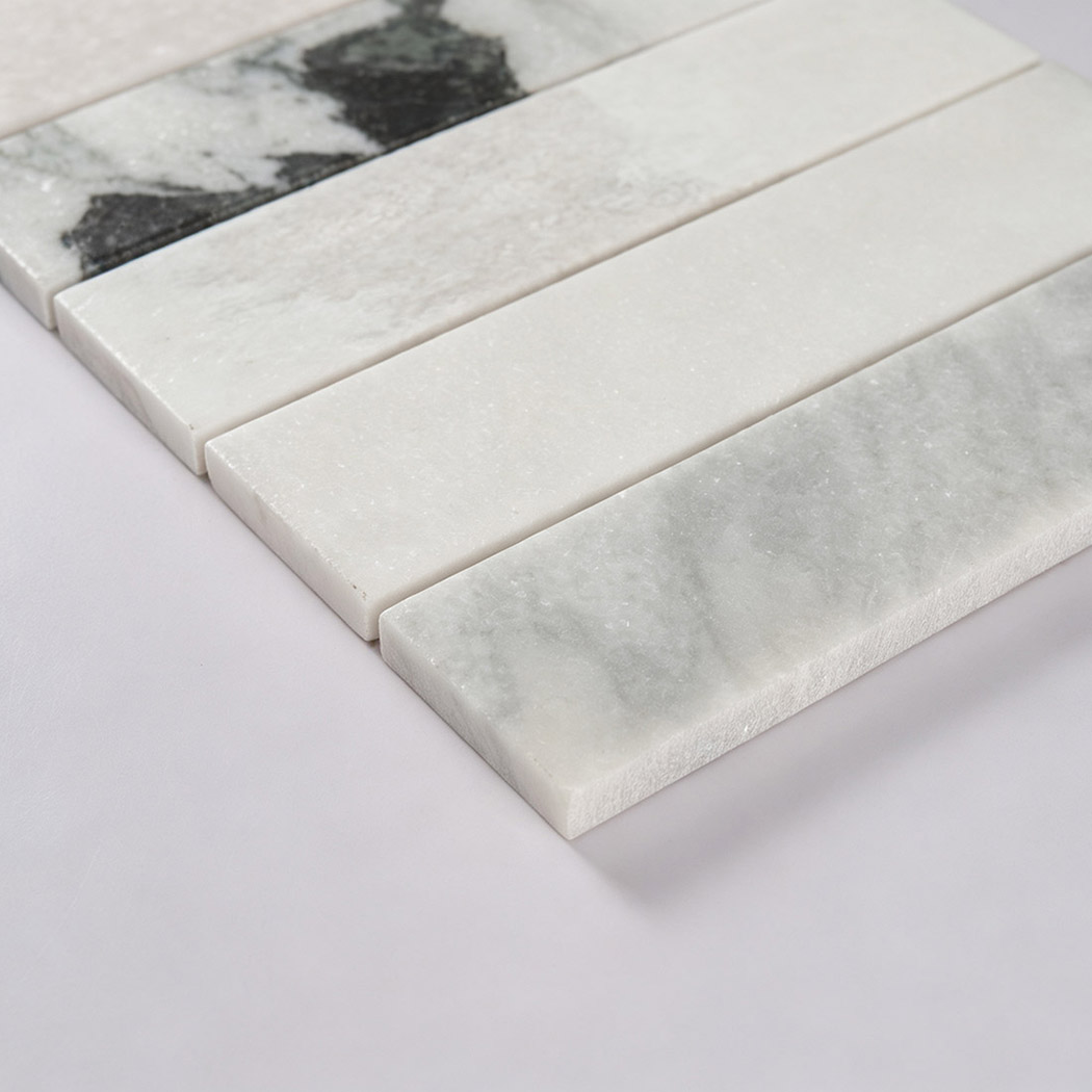 Angled close-up showing the smooth surface and thickness of white marble strips