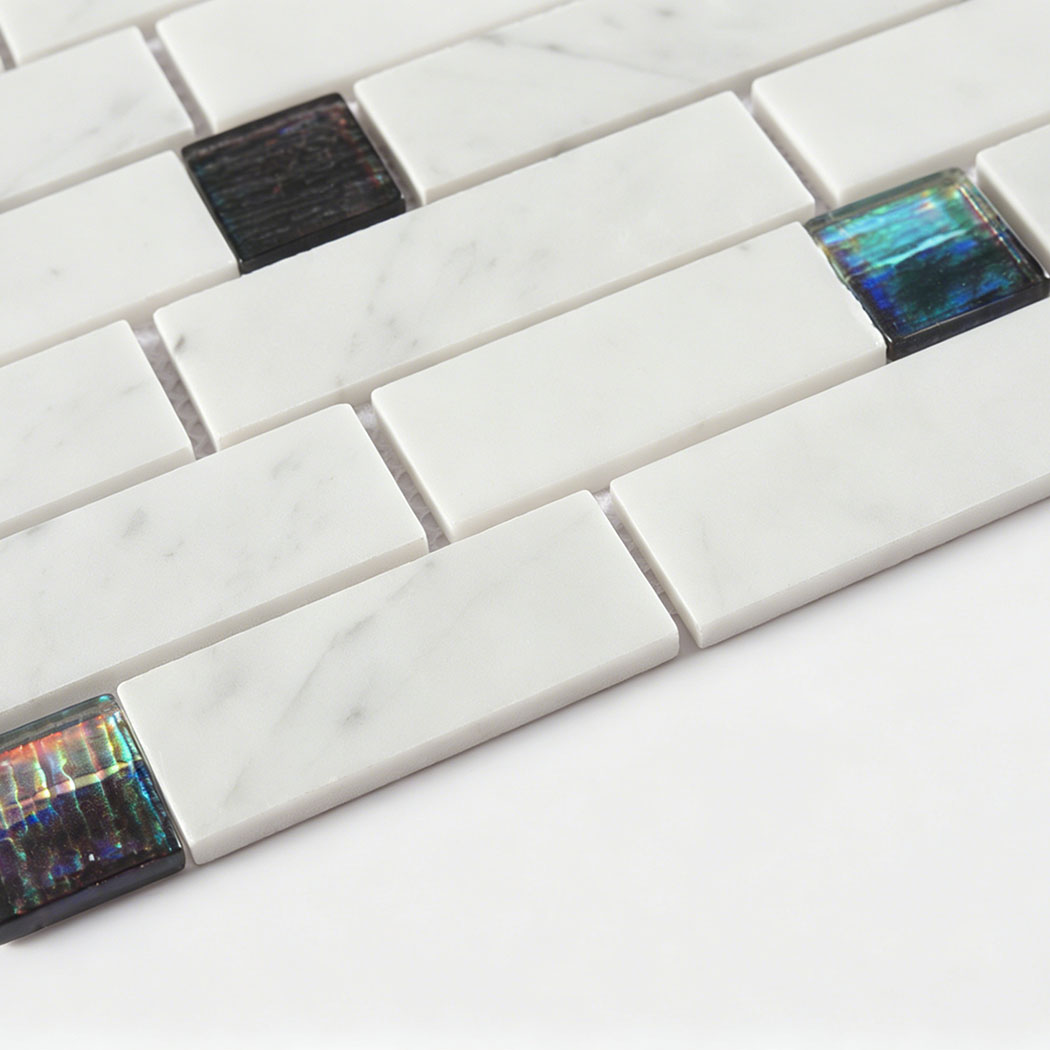Low angle detail of white marble subway strips with glossy iridescent glass inserts