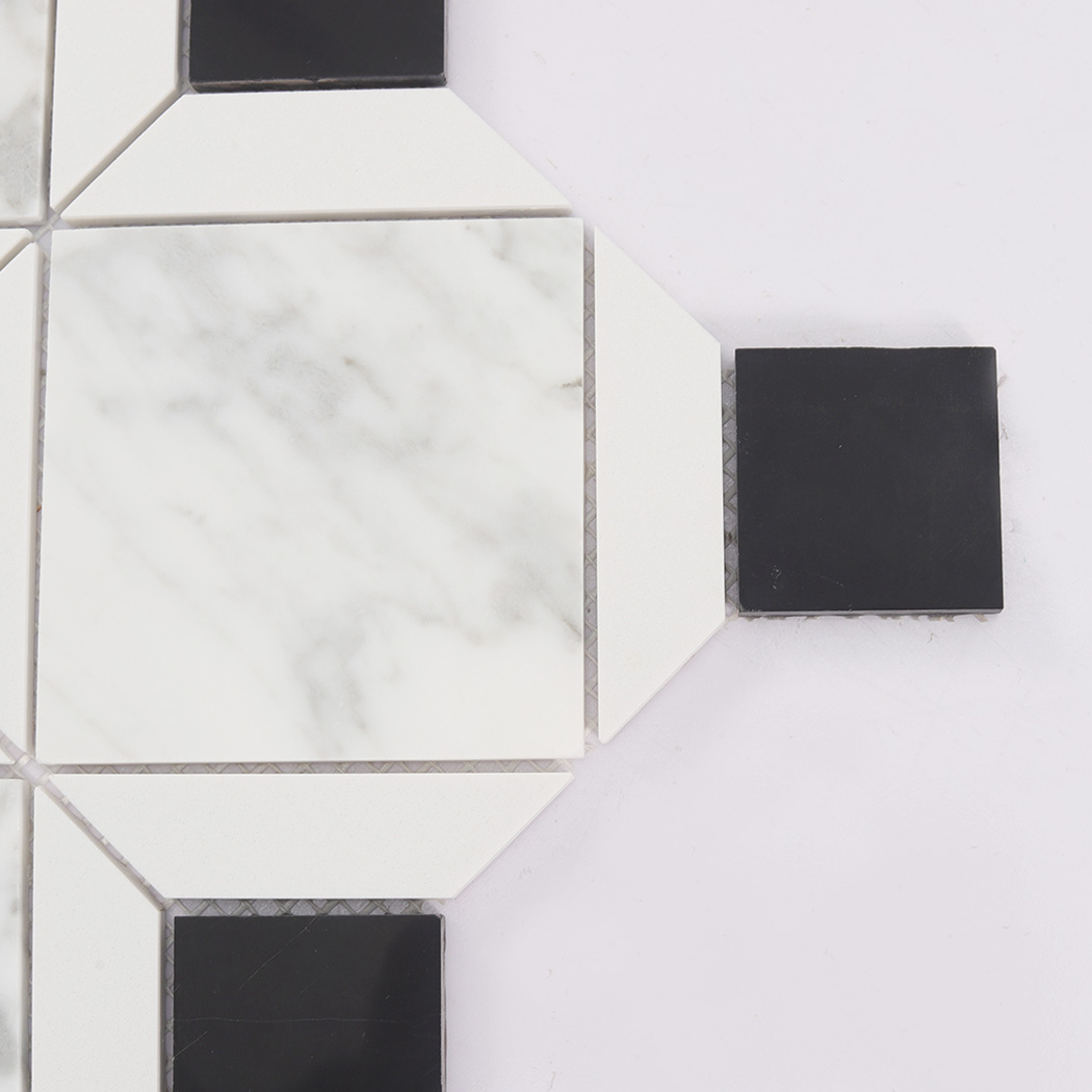 Close up of white marble mosaic tile with a black square insert