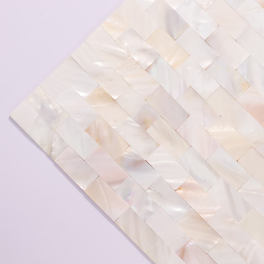 Angled close-up of polished white mother of pearl mosaic tile