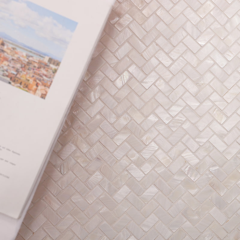 Iridescent close-up of white shell herringbone mosaic tile