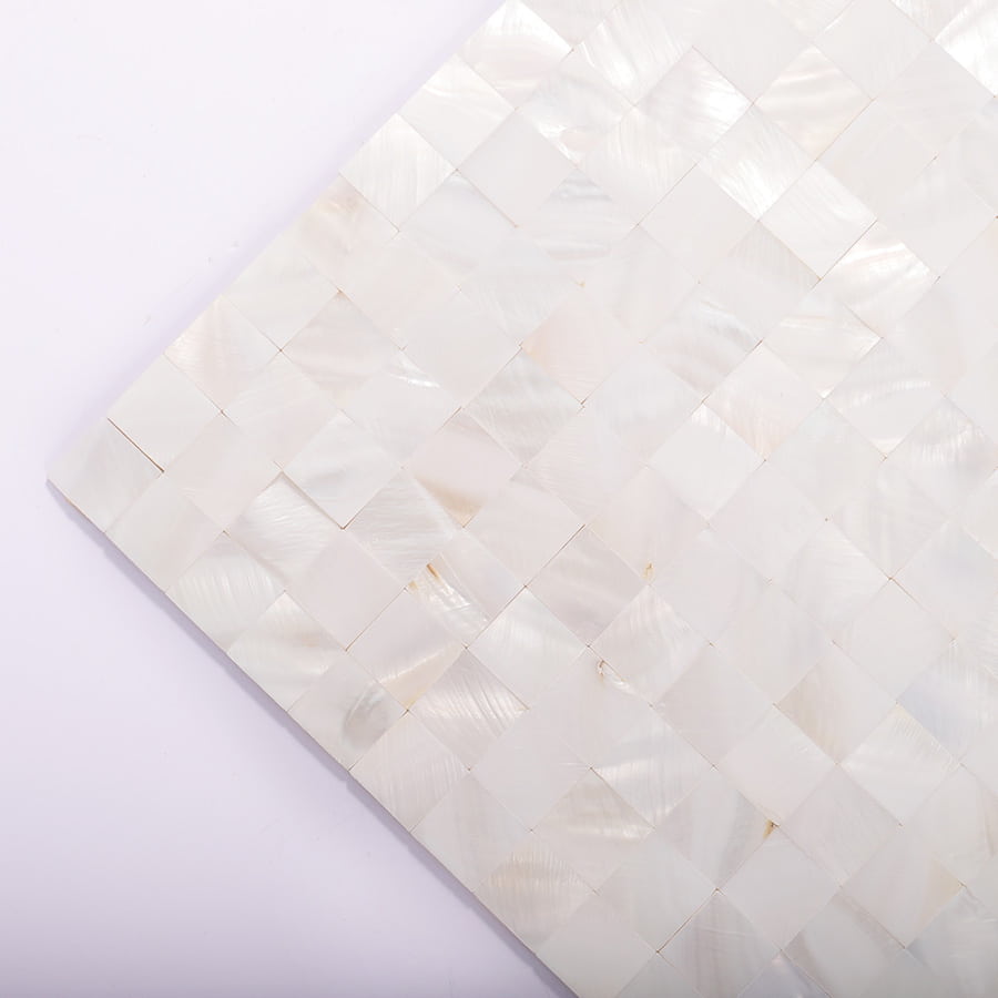 Angled view of square white mother of pearl mosaic tile sheet