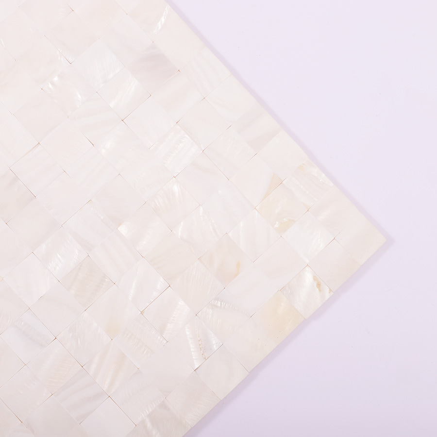Corner close-up showing seamless layout of white shell mosaic tiles