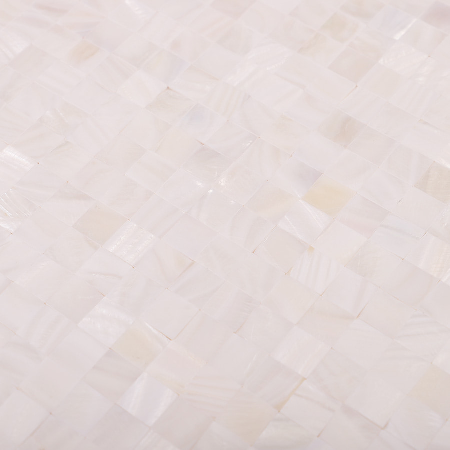 Detailed view of the surface texture and shimmer of white shell mosaic