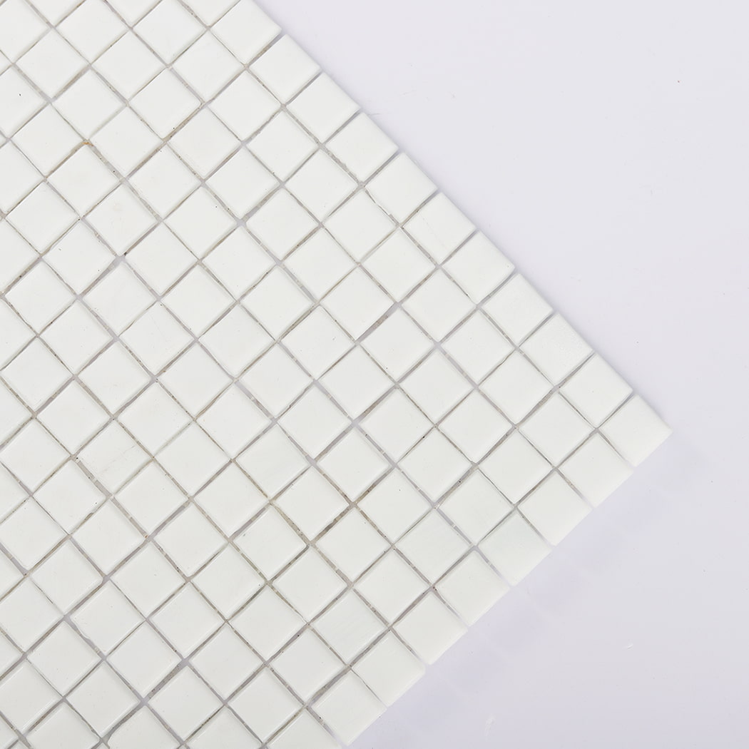 Close-up of the corner of a white square mosaic tile sheet
