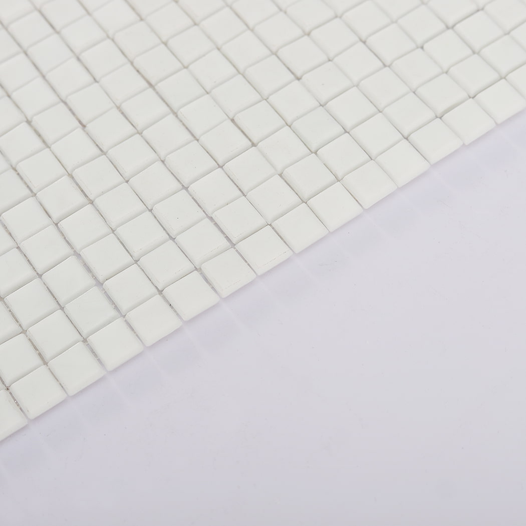 Angled side view of white square mosaic tiles showing thickness and edges