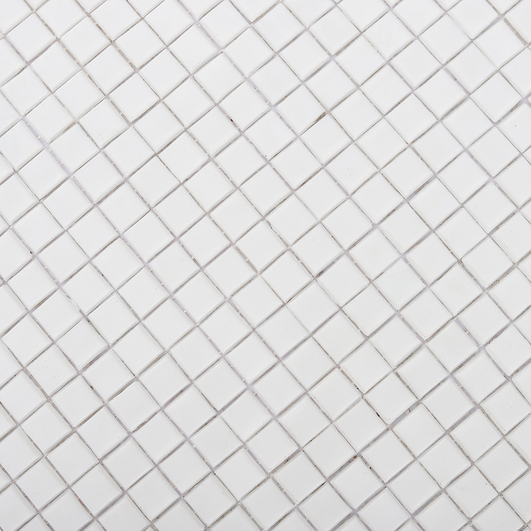 Detailed surface texture of white square mosaic tiles arranged in a grid