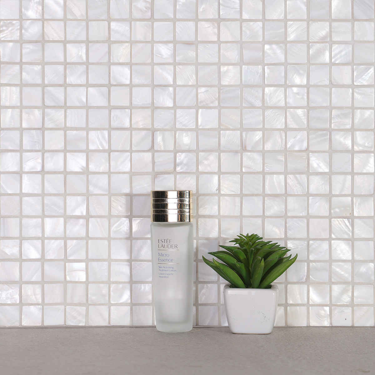 White square mother of pearl mosaic tiles on bathroom wall
