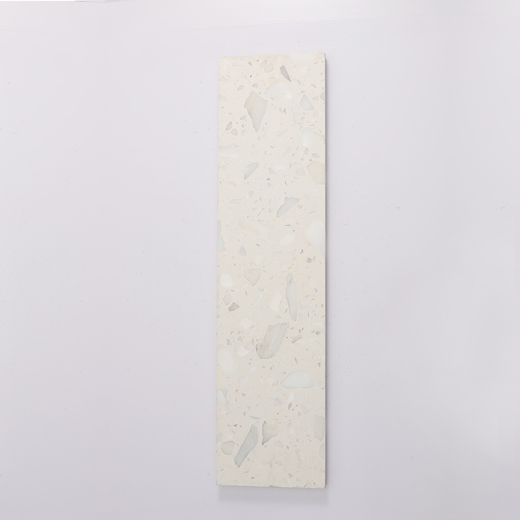 Back view of white terrazzo fluted tile with flat surface and stone chips