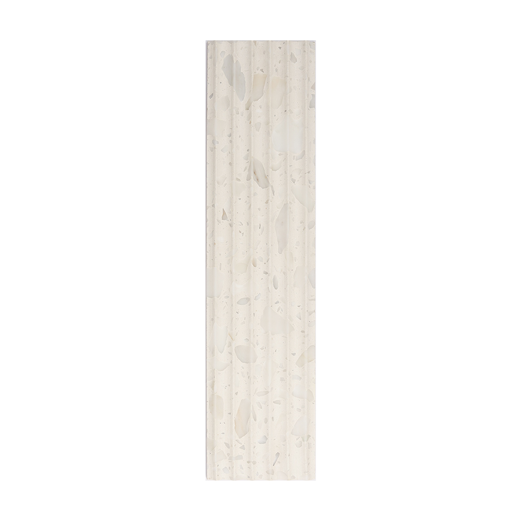 Front view of a white terrazzo fluted wall tile with soft stone chips