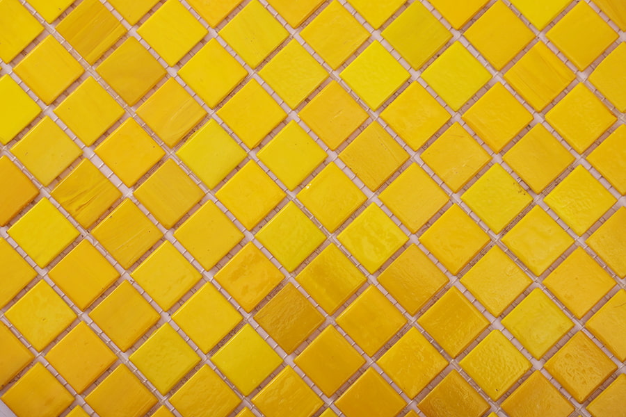Full sheet of yellow glass mosaic tiles in diagonal layout