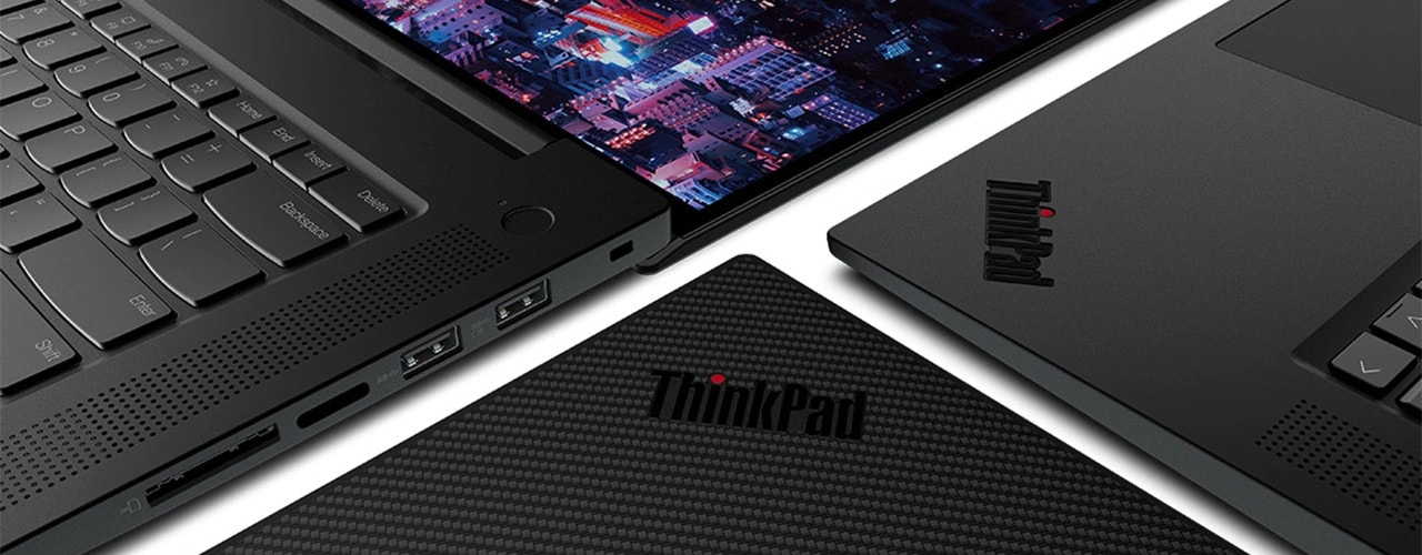 Close up of three Lenovo ThinkPad P1 Gen 6 (16″ Intel) mobile workstations, all laid flat next to each other. 1) opened flat, 180 degrees, showing part of keyboard & display; 2) closed, showing part of textured top cover & ThinkPad logo; and 3) opened, showing part of keyboard & ThinkPad logo