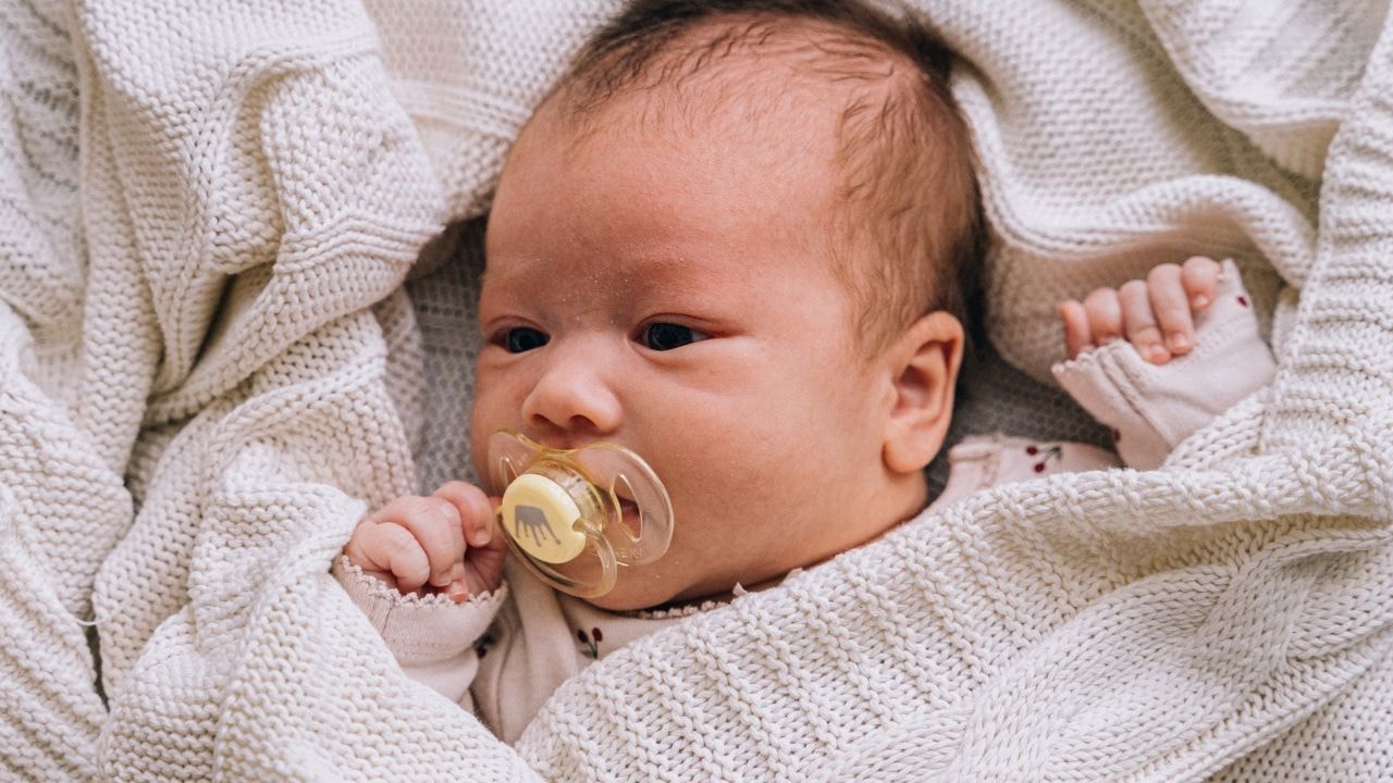 Baby wrapped in a knitted, breathable, and cozy blanket