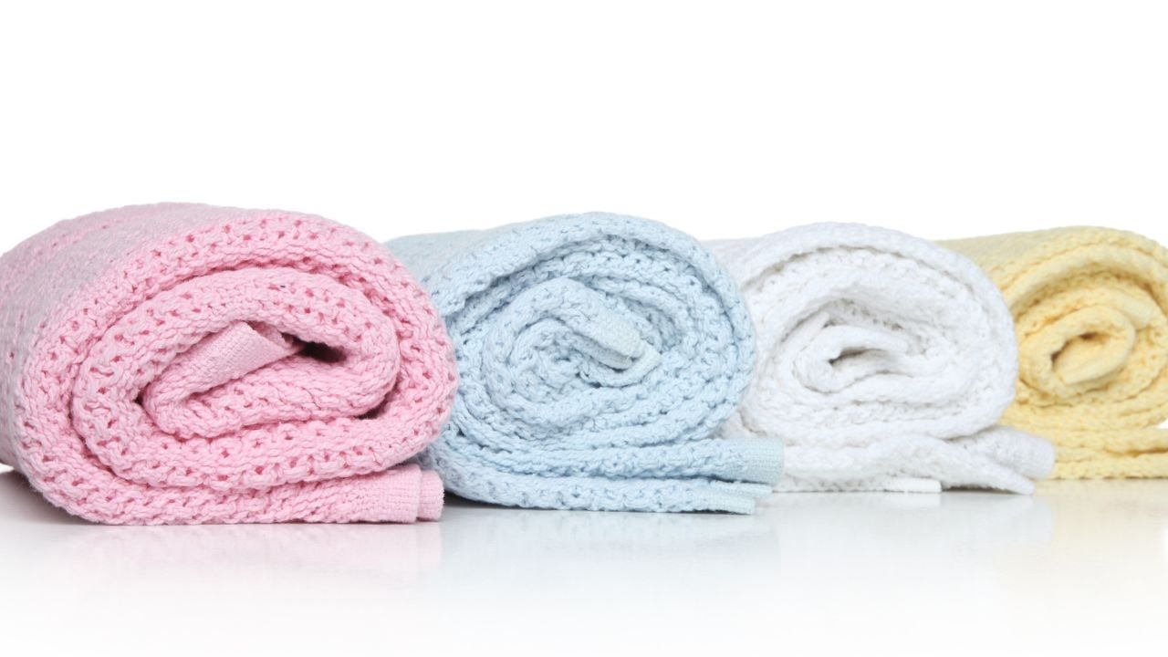 Different colours of hooded baby towels indicate different sizes