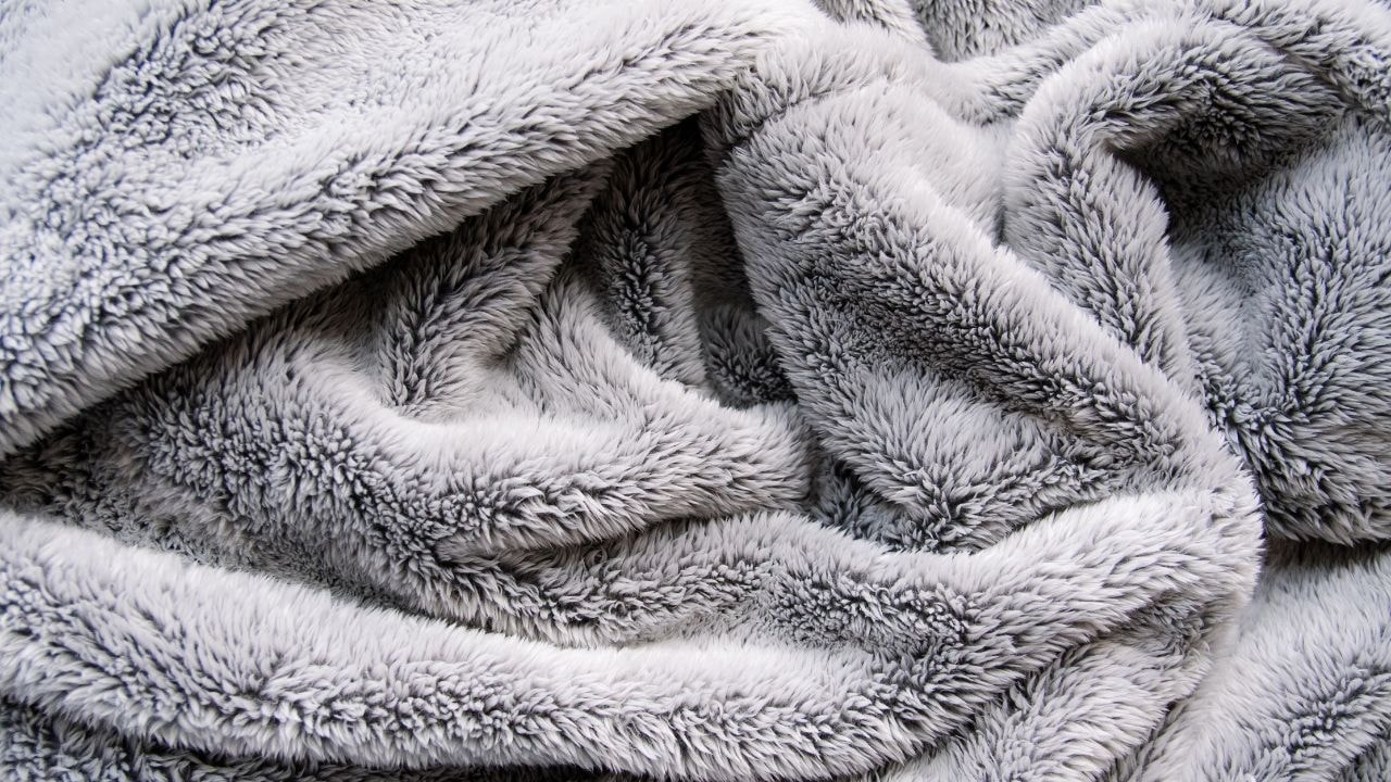 A cozy, fluffy gray Multi-purpose Blanket, suitable for babies to keep them warm
