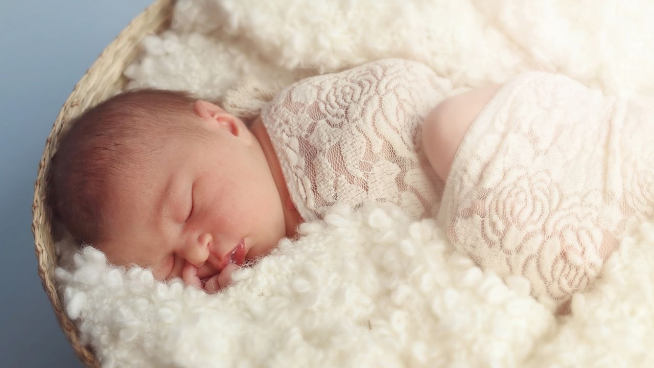 Newborn baby sleeping in a cozy soft blanket