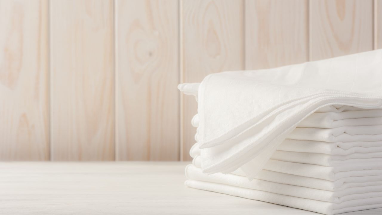 Stacked white high absorbent organic cotton baby bath towels