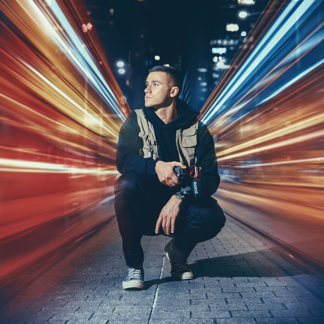 Man crouching with camera mounted with VideoMic GO II