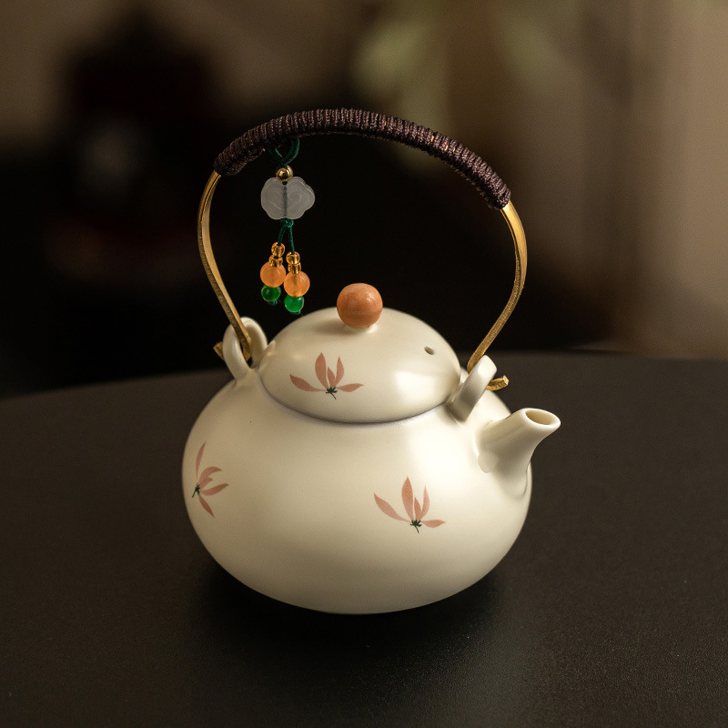 米黃釉蘭花綁繩提梁壺