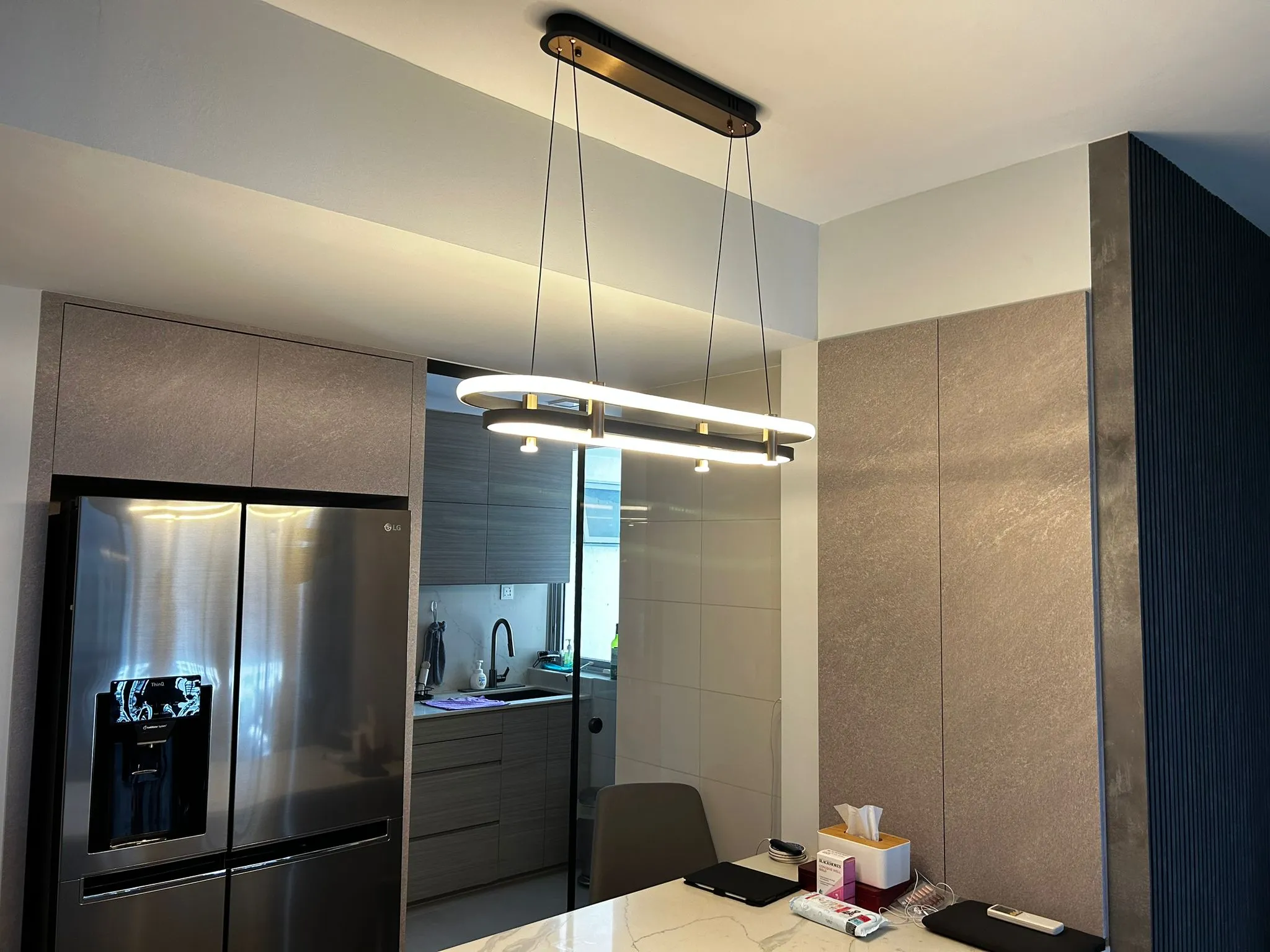 Modern oval pendant over a minimalist dining table.