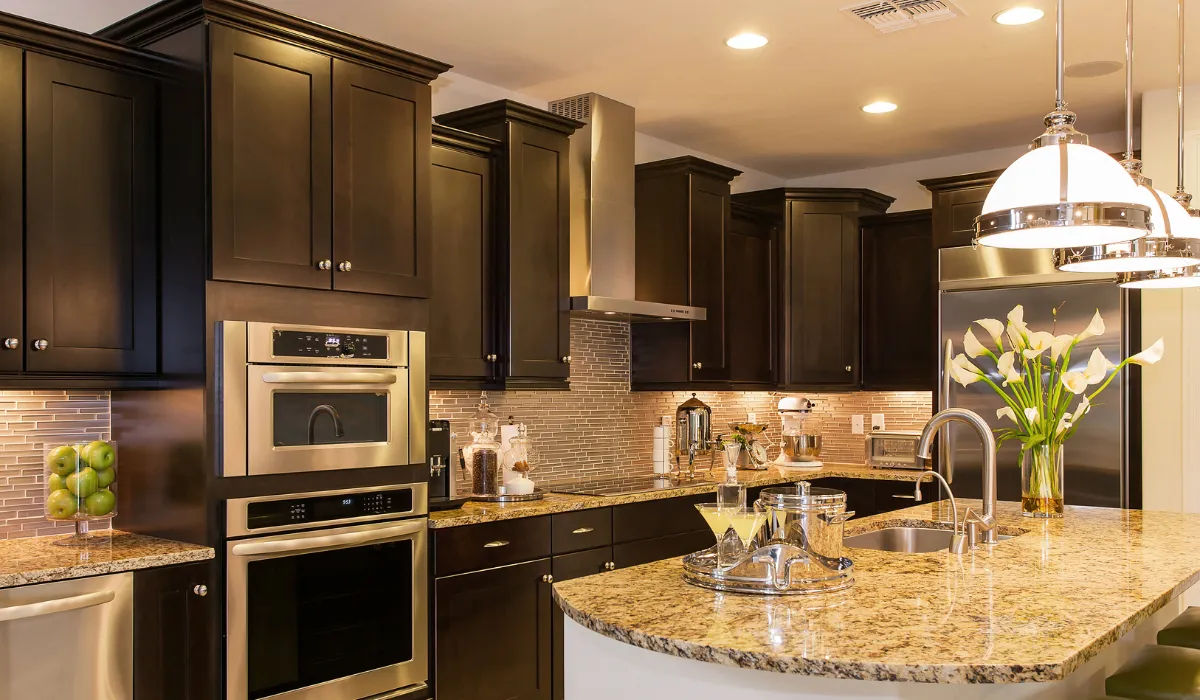 Warmly lit kitchen with pendant and recessed lighting
