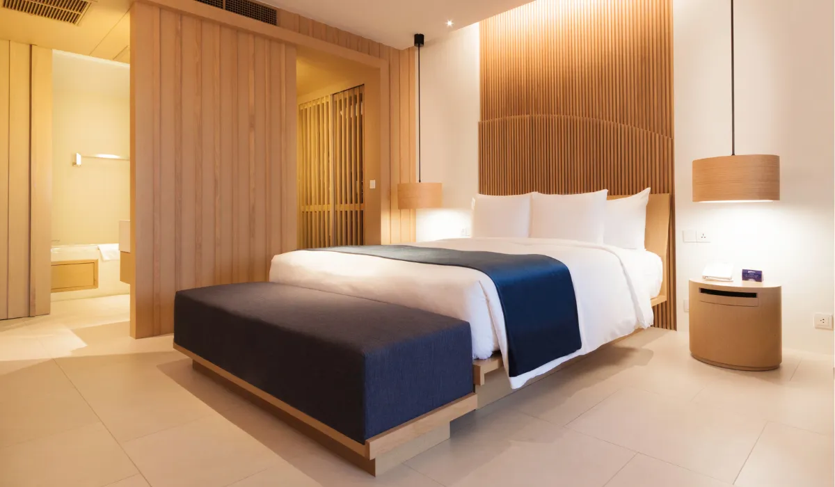 Elegant hotel room with warm ambient lighting and modern wood panel decor for a cozy feel