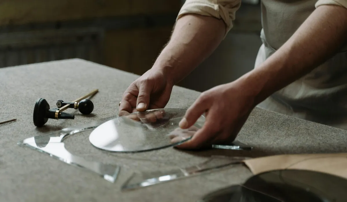 Skilled artisan shaping glass for a handcrafted lighting fixture.