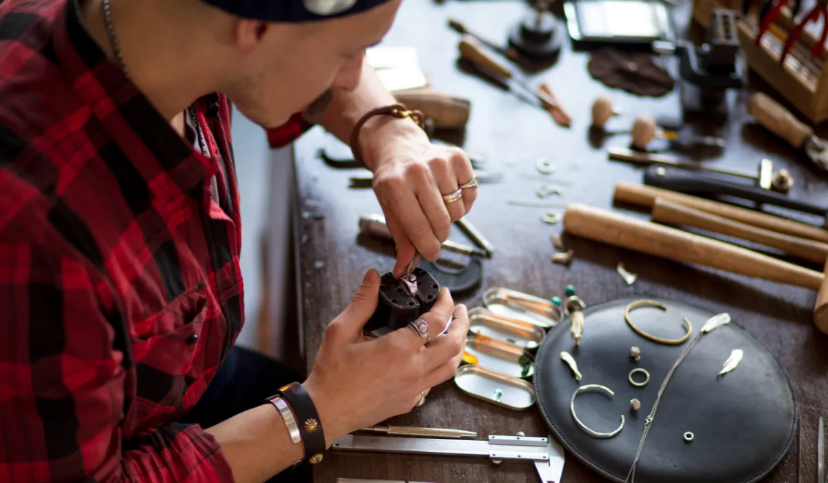 Skilled artisan working on handcrafted lighting components for bespoke fixture design.