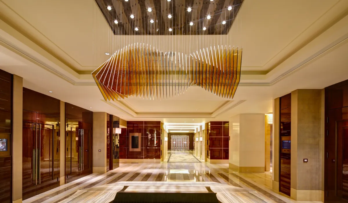 Luxury hotel lobby with a modern chandelier and ambient lighting for a grand entrance.