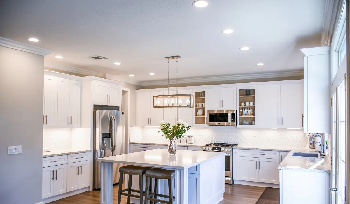Contemporary kitchen with pendant and recessed lighting, creating a bright and inviting space.