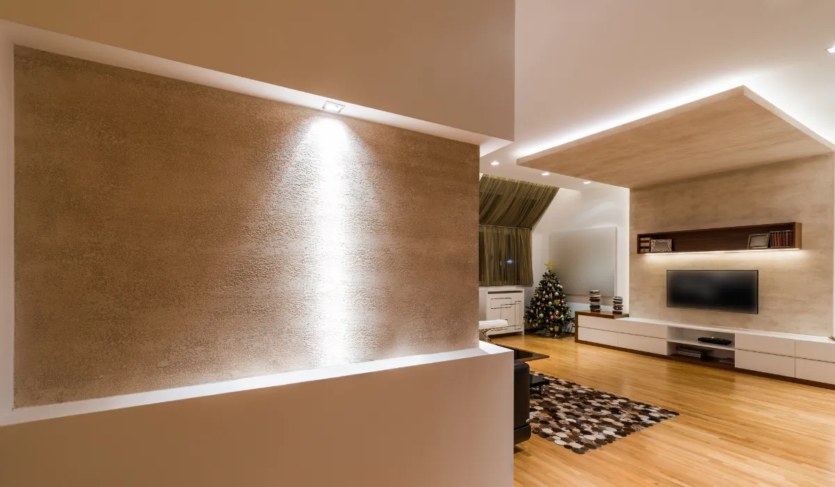 Modern recessed and cove lighting enhancing a sleek, minimalist living room ambiance.