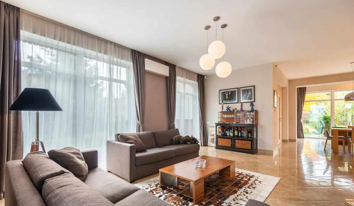 Modern living room with pendant and floor lamps, creating a cozy and stylish ambiance.