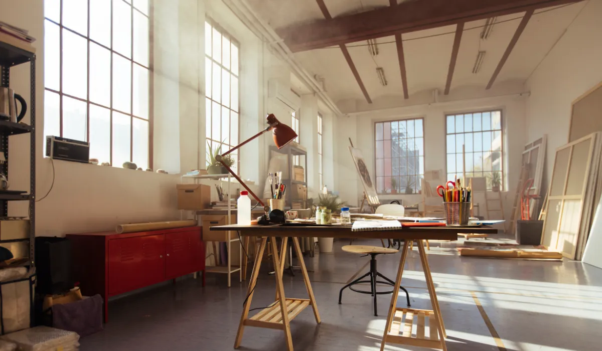 Bright studio workspace with large windows allowing natural light to enhance creativity and productivity.