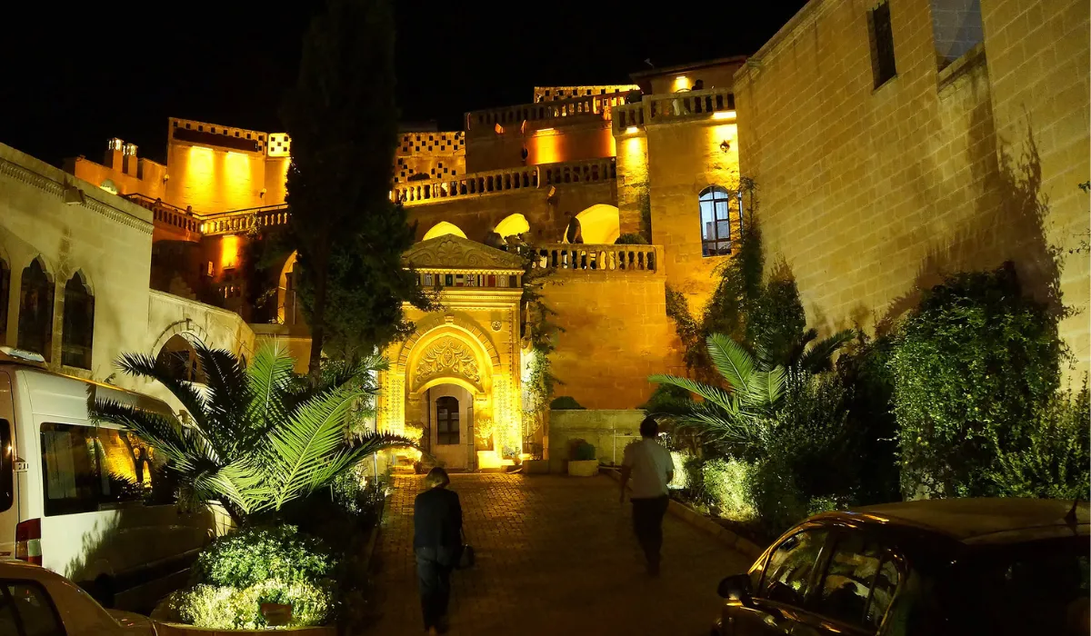 Historic hotel facade illuminated with warm outdoor lighting for a charming night ambiance.