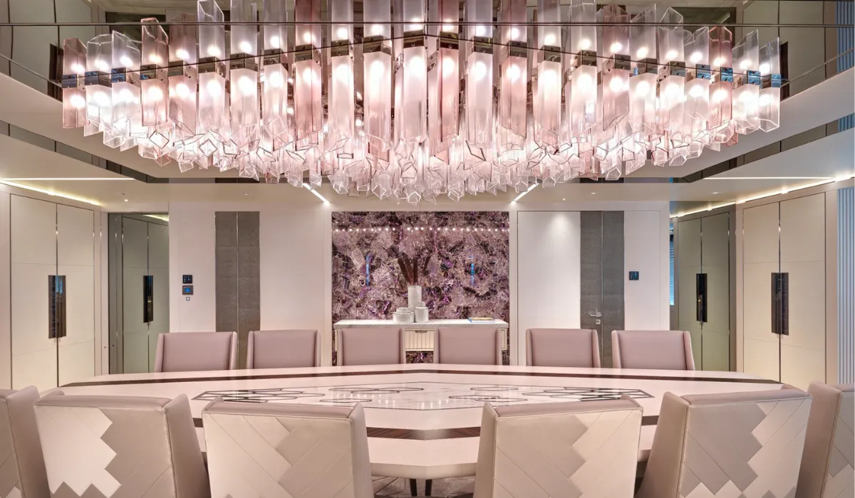 Bespoke crystal chandelier in a luxurious conference room with personalized lighting design.