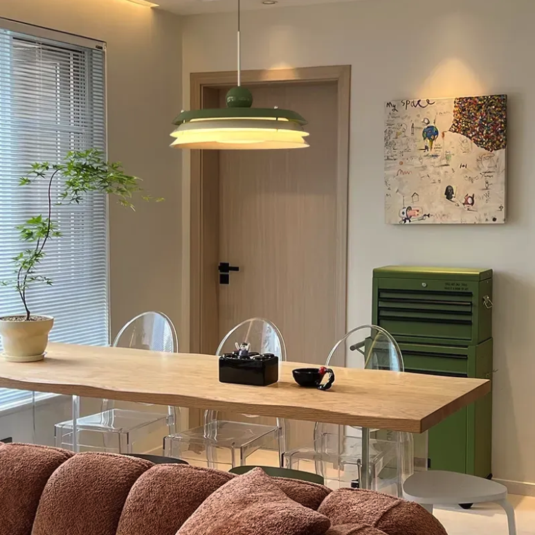 Mid century modern pendant light over a millennial apartment dining