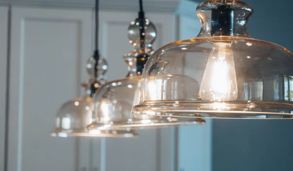 Durable quality glass pendant lights illuminating a contemporary kitchen space.