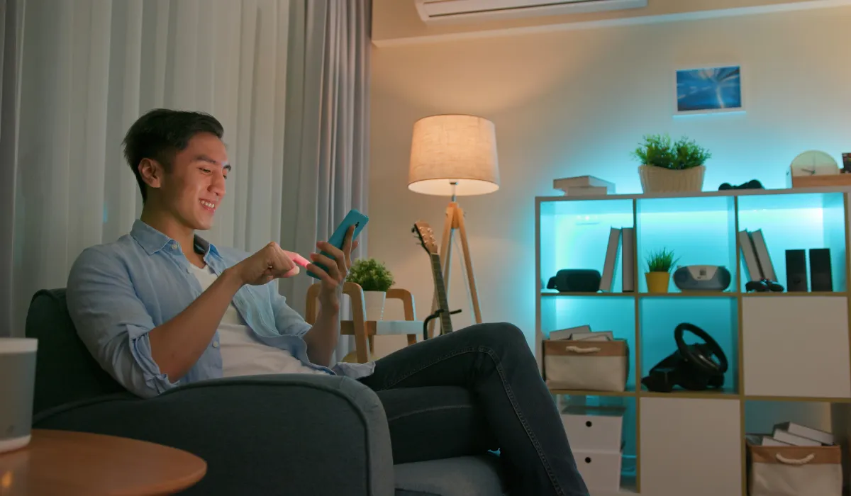 Smart floor lamp controlled via mobile app in a modern, tech-savvy living room.