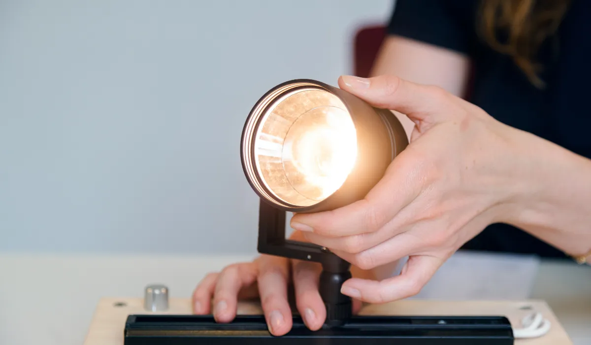 Close-up of track lighting being tested for quality and performance.