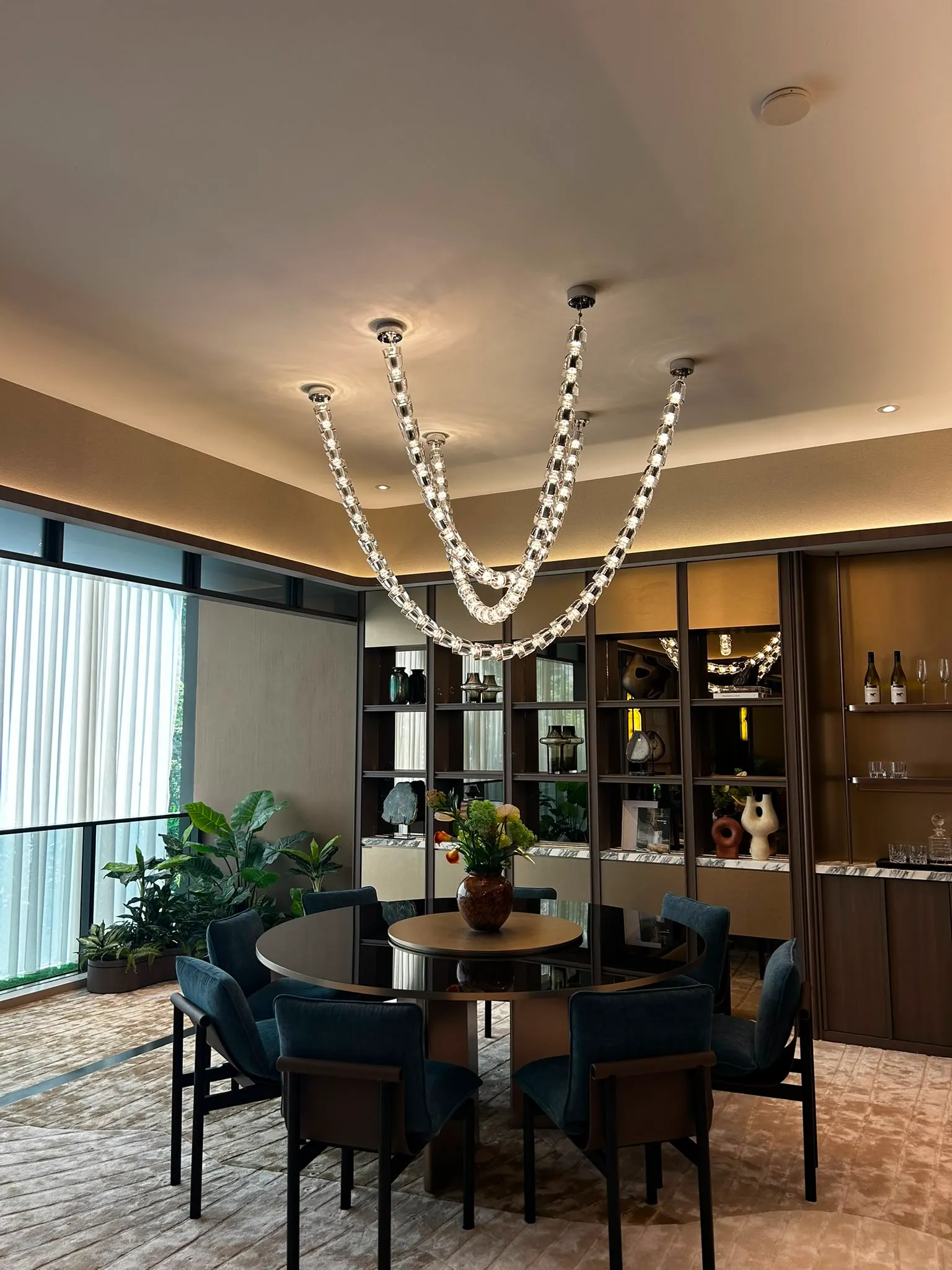 Custom handcrafted designer lighting fixture illuminating an elegant modern room.