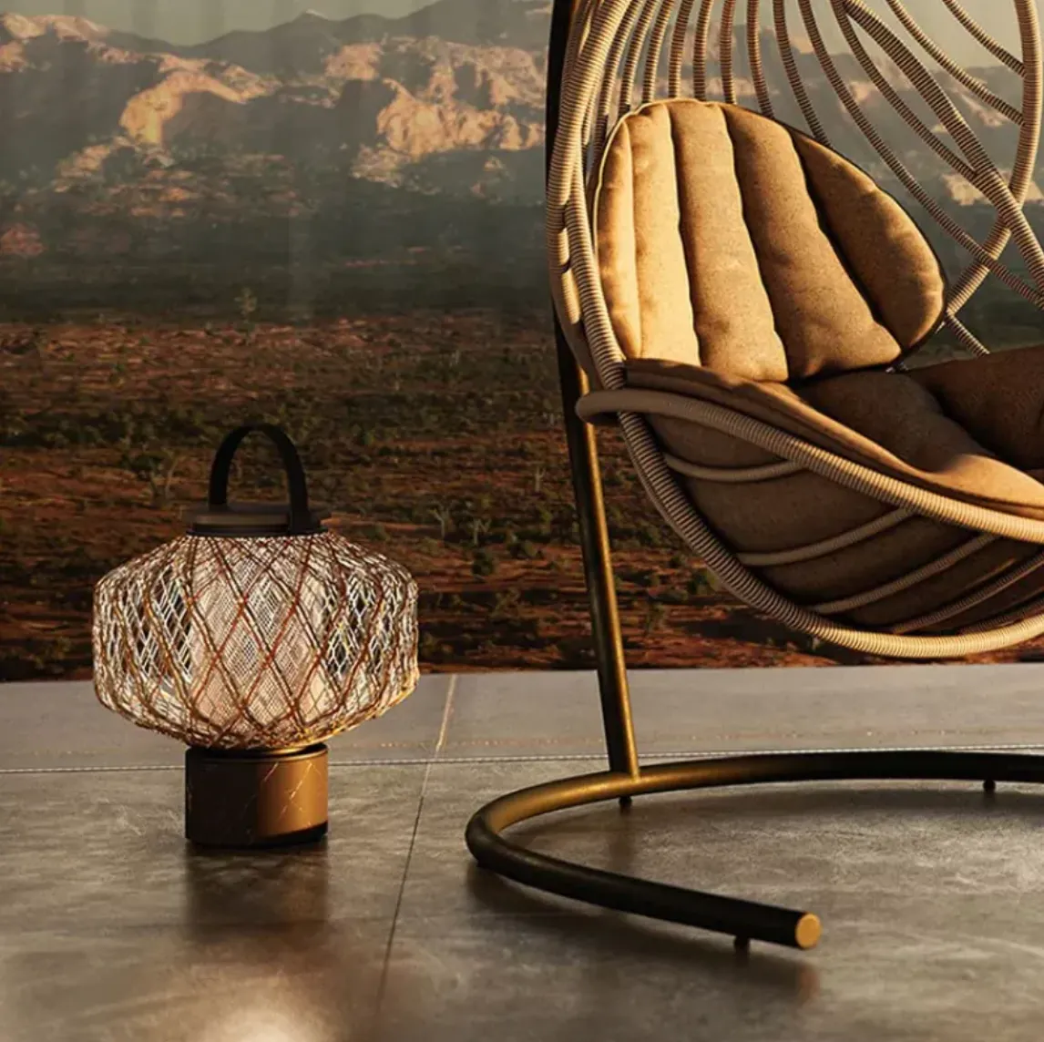 Outdoor rattan lantern with warm glow beside a modern hanging chair, set against a scenic mountain view.