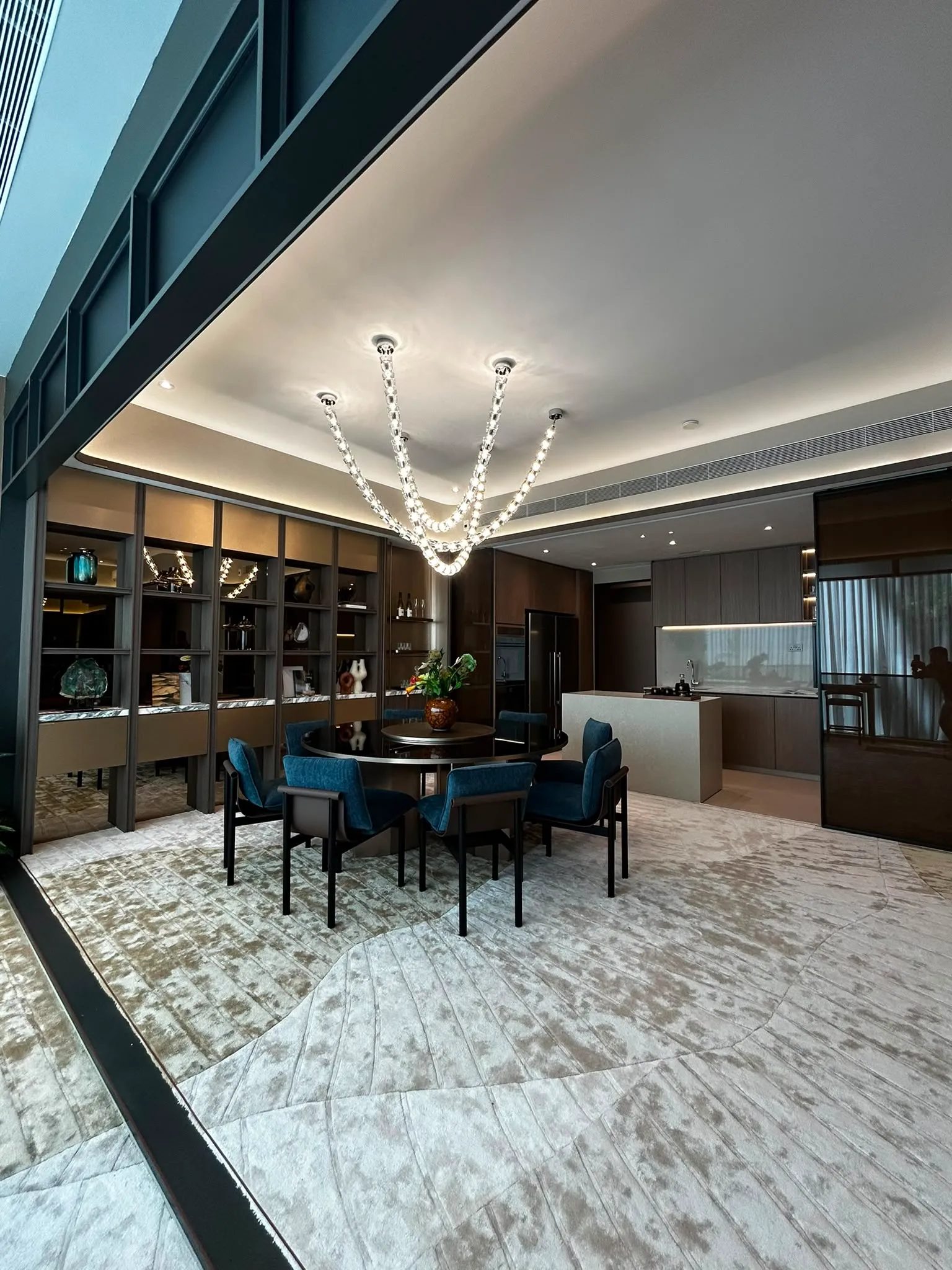 Luxury bespoke designer pendant light centered over an elegant dining area.