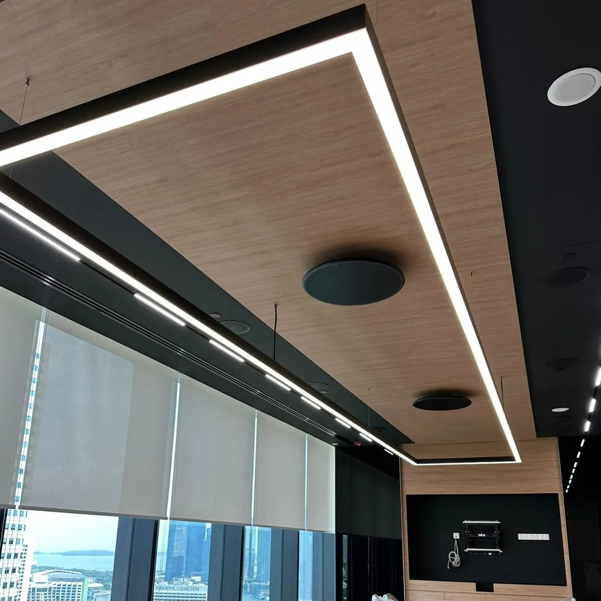 Close-up of suspended LED panel lighting in a boardroom ceiling design.