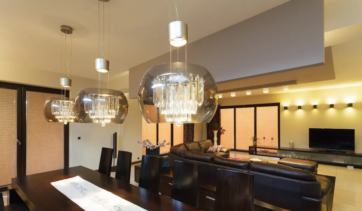 Elegant dining space with glass pendant lights and a view of the cozy living room.